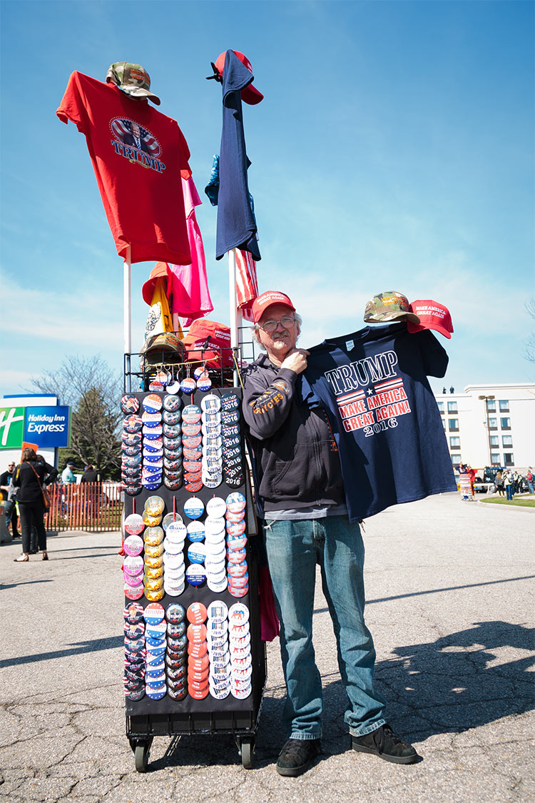 The rally also attracted a cottage industry of Trump paraphernalia vendors, many who travel from Trump rally to Trump rally selling buttons, shirts, and hats. This guy told us his hottest item is the famous red "Make America Great Again" baseball cap. His bestselling button is one that reads "Bomb the Hell out of ISIS" with an explosion in the background. Also selling well: "Hot Chicks for Trump 2016" and "Trump 2016: Finally, Someone with Balls!"