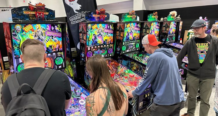 People playing pinball at the 2026 Midwest Gaming Classic in Milwaukee, Wisconsin